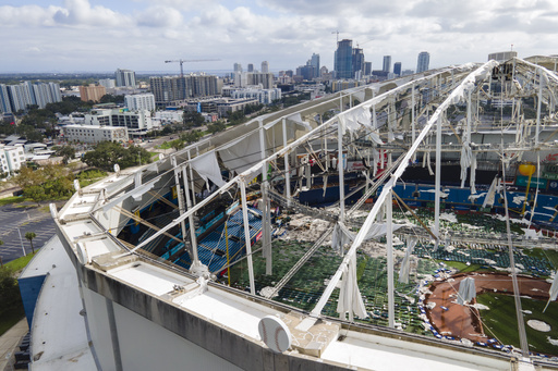 FILE - The roof of the Tropicana Field is damaged the morning after Hurricane Milton hit the region Oct. 10, 2024, in St. Petersburg, Fla. (AP Photo/Julio Cortez, File)
