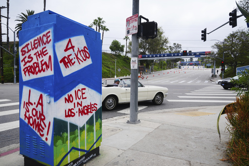 An art installation critical of immigration enforcement stands outside Dodger Stadium on Friday, June 20, 2025, in Los Angeles. (AP Photo/Damian Dovarganes)