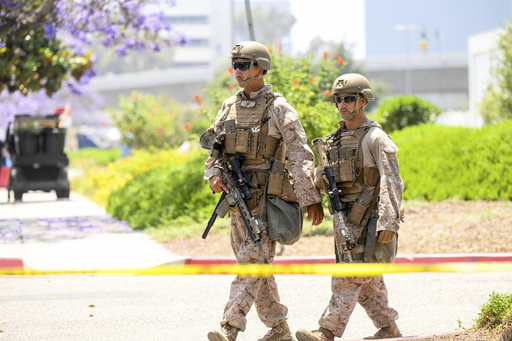 U.S Marines work outside of a federal building, Friday, June 13, 2025, in Los Angeles (AP Photo/Noah Berger)