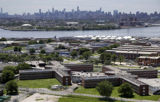 FILE - The Rikers Island jail complex stands in New York with the Manhattan skyline in the background June 20, 2014. (AP Photo/Seth Wenig, File)