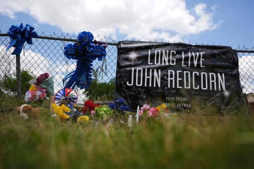 Candles, flowers, and notes are placed at a makeshift memorial in San Antonio, on Thursday, June 5, 2025, for voice actor Jonathan Joss who was recently killed. (AP Photo/Eric Gay)