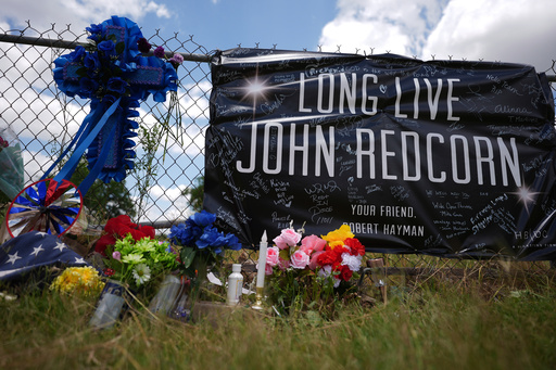 Candles, flowers, and notes are placed at a makeshift memorial in San Antonio, on Thursday, June 5, 2025, for voice actor Jonathan Joss who was recently killed. (AP Photo/Eric Gay)