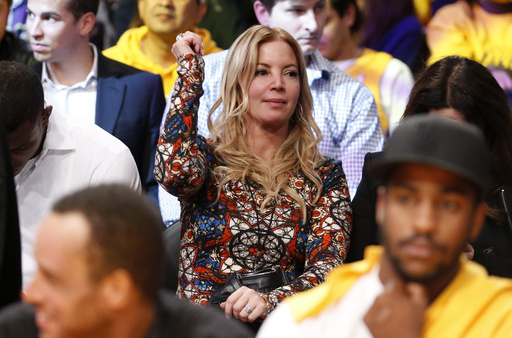 FILE - Los Angeles Lakers President Jeanie Buss dances in her seat to music as she attends the NBA basketball game between the Lakers and the Los Angeles Clippers in Los Angeles, Oct. 29, 2013. (AP Photo/Danny Moloshok, File)