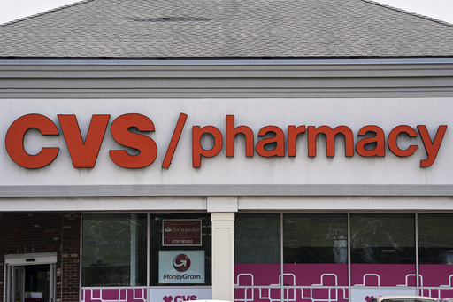 FILE - Signage hangs above a CVS pharmacy location in Philadelphia, June 6, 2025. (AP Photo/Matt Rourke, File)
