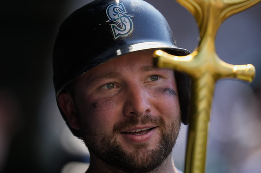 Seattle Mariners' Cal Raleigh holds the "home run trident" after hitting a two-run a home run during the seventh inning of a baseball game against the Chicago Cubs, Friday, June 20, 2025, in Chicago. (AP Photo/Erin Hooley)