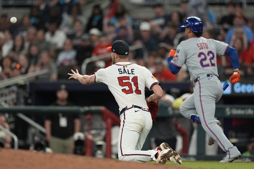 Atlanta Braves pitcher Chris Sale (51) fields a ball hit by New York Mets' Juan Soto (22) in the ninth inning of a baseball game, Wednesday, June 18, 2025, in Atlanta. (AP Photo/Mike Stewart)