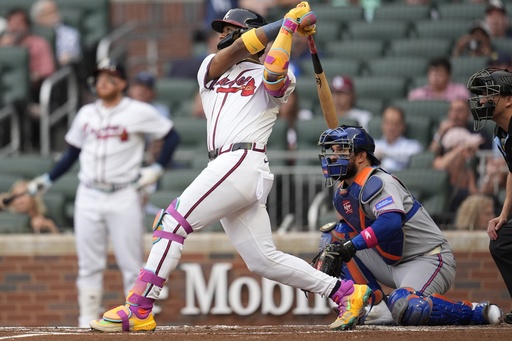 Atlanta Braves outfielder Ronald Acuña Jr. (13) hits a solo home run against the New York Mets in the first inning of a baseball game, Wednesday, June 18, 2025, in Atlanta. (AP Photo/Mike Stewart)