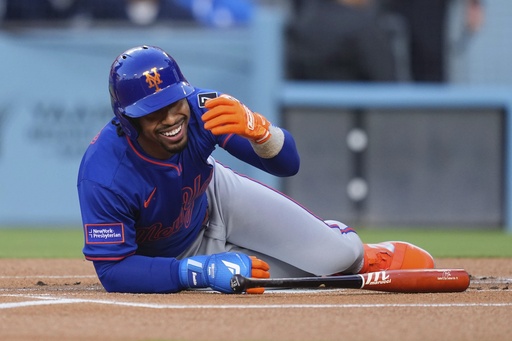 New York Mets' Francisco Lindor reacts toward the Los Angeles Dodgers' dugout after being hit with a pitch during the first inning of a baseball game Wednesday, June 4, 2025, in Los Angeles. (AP Photo/Mark J. Terrill)