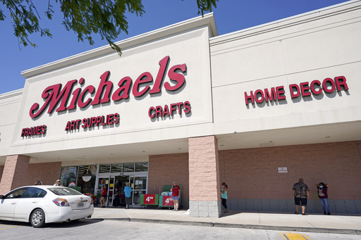 FILE - In this April 24, 2020 file photo, customers lineup outside a Michaels store in Houston. (AP Photo/David J. Phillip, File)