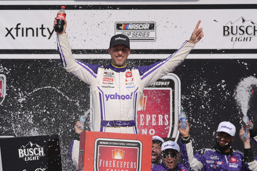 Denny Hamlin celebrates his victory in a NASCAR Cup Series auto race at Michigan International Speedway in Brooklyn, Mich., Sunday, June 8, 2025. (AP Photo/Paul Sancya)