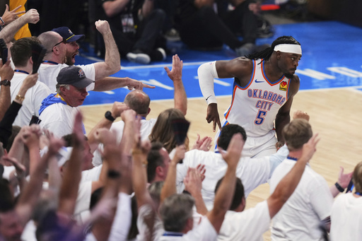 Oklahoma City Thunder guard Luguentz Dort (5) celebrates after making a 3-pointer during the first half of Game 1 of the NBA Finals basketball series against the Indiana Pacers Thursday, June 5, 2025, in Oklahoma City. (AP Photo/Nate Billings)