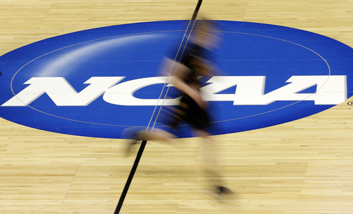 FILE - In this photo taken with a slow shutter speed, Wichita State's Ron Baker runs during practice for the NCAA college basketball tournament, March 20, 2014, in St. Louis. (AP Photo/Charlie Riedel, file)