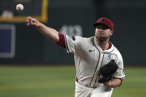 Arizona Diamondbacks pitcher Corbin Burnes throws against the Washington Nationals in the first inning during a baseball game, Sunday, June 1, 2025, in Phoenix. (AP Photo/Rick Scuteri)