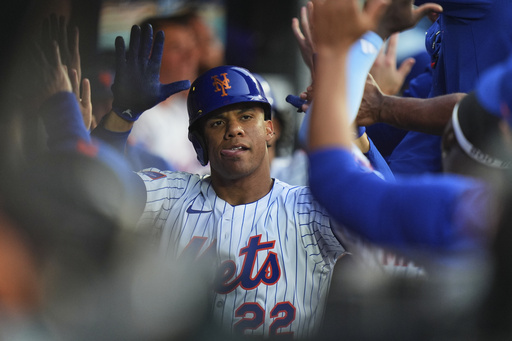 New York Mets' Juan Soto celebrates with teammates after hitting a two-run home run during the third inning of a baseball game against the Washington Nationals Wednesday, June 11, 2025, in New York. (AP Photo/Frank Franklin II)