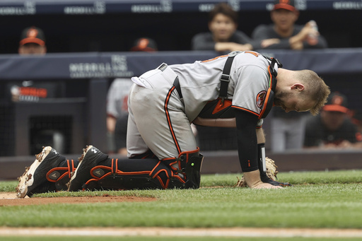 Baltimore Orioles catcher Maverick Handley reacts after colliding with New York Yankees' Jazz Chisholm Jr. during the second inning of a baseball game Sunday, June 22, 2025, in New York. (AP Photo/Pamela Smith)