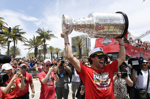 Florida Panthers' Carter Verhaeghe carries the Stanley Cup during the NHL hockey team's Stanley Cup championship celebration, Sunday, June, 22, 2025, in Fort Lauderdale, Fla. (AP Photo/Michael Laughlin)