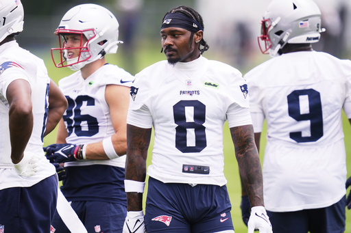 New England Patriots wide receiver Stefon Diggs (8) stands with teammates during an NFL football practice, Monday, June 9, 2025, in Foxborough, Mass. (AP Photo/Charles Krupa)