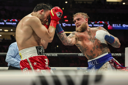 Jake Paul, right, punches Julio Cesar Chavez Jr. during their cruiserweight boxing match on Saturday, June 28, 2025, in Anaheim, Calif. (AP Photo/Etienne Laurent)