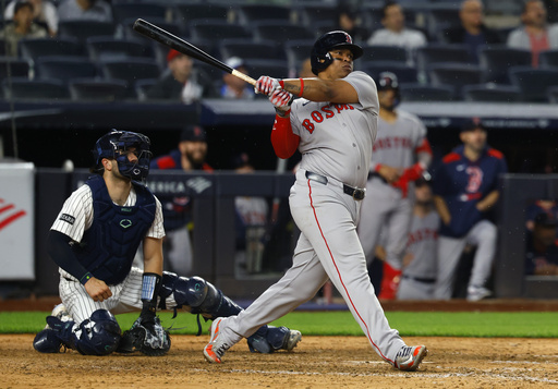 Boston Red Sox designated hitter Rafael Devers (11) follows through on a home run during the ninth inning of a baseball game against the New York Yankees, Sunday, June 8, 2025, in New York. (AP Photo/Noah K. Murray)