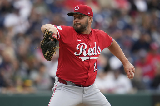 Cincinnati Reds' Wade Miley pitches in the first inning of a baseball game against the Cleveland Guardians in Cleveland, Monday, June 9, 2025. (AP Photo/Sue Ogrocki)