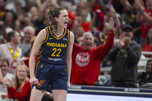 Indiana Fever guard Caitlin Clark (22) celebrates after a three-point basket against the Connecticut Sun in the second half of a WNBA basketball game in Indianapolis, Tuesday, June 17, 2025. (AP Photo/Michael Conroy)