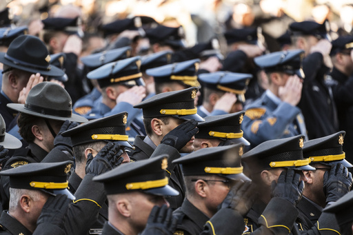 FILE - Law enforcement officers gather as an honor guard carries the casket containing the remains of Temple University Police Officer Christopher Fitzgerald from the Cathedral Basilica of Saints Peter and Paul in Philadelphia, Feb. 24, 2023. (AP Photo/Matt Rourke, File)