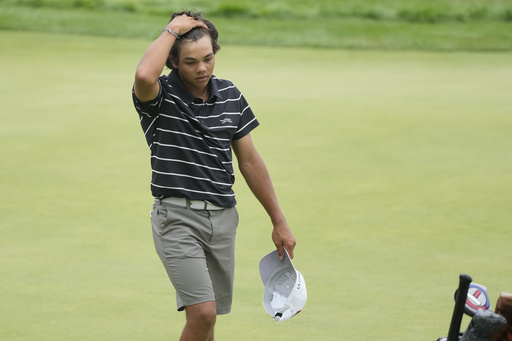 FILE - Charlie Woods walks off the 18th green during the first round of stroke play of the U.S. Junior Amateur Golf Championship, in Bloomfield Township, Mich., July 22, 2024. (AP Photo/Carlos Osorio, File)