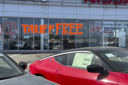 FILE - A Tariff Free sign to attract vehicle shoppers is at an automobile dealership in Totowa, N.J., on April 30, 2025. (AP Photo/Ted Shaffrey)
