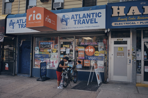 A young man arrives at a travel agency on Thursday, June 5, 2025, in the Brooklyn borough of New York. (AP Photo/Andres Kudacki)