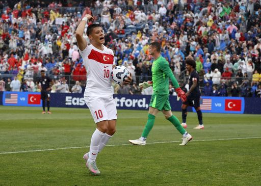 Turkey forward Arda Güler (10) reacts after scoring a goal past United States goalie Matt Freese (25) during the first half of an international friendly soccer game, Saturday, June 7, 2025, in East Hartford, Conn. (AP Photo/Mary Schwalm)