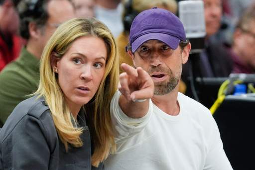 FILE - Justin Ishbia, right, brother of Phoenix Suns owner Mat Ishbia, and his wife Kristen Ishbia, left, sit courtside during the first half of an NBA basketball game against the Chicago Bulls, Saturday, Feb. 22, 2025, in Chicago. (AP Photo/Erin Hooley, File)