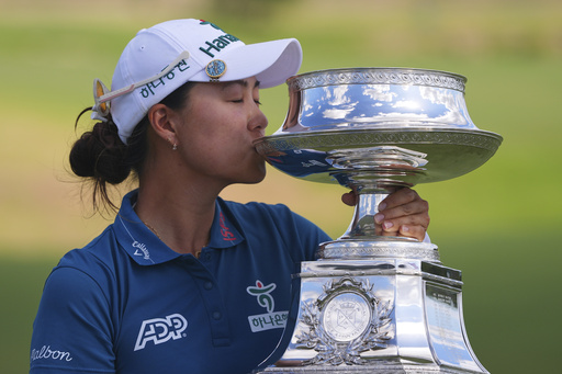 Minjee Lee kisses the trophy after winning the Women's PGA Championship golf tournament Sunday, June 22, 2025, in Frisco, Texas. (AP Photo/LM Otero)