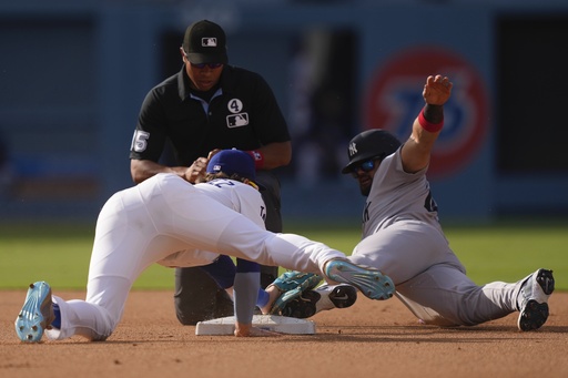 New York Yankees' Jasson Dominguez, right, steals second as Los Angeles Dodgers first baseman Enrique Hernandez puts a late tag on him during the fifth inning of a baseball game Sunday, June 1, 2025, in Los Angeles. (AP Photo/Mark J. Terrill)