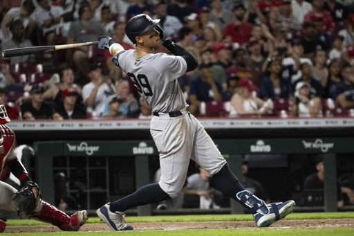 New York Yankees' Aaron Judge hits the ball in the eighth inning of a baseball game against the Cincinnati Reds, Wednesday, June 25, 2025, in Cincinnati. (AP Photo/Michael Swensen)