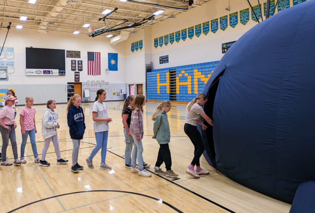 Hamlin Elementary students line up for their turn visiting a traveling planetarium sponsored by the South Dakota Discovery Center. (Anya Kamenetz for The Hechinger Report)