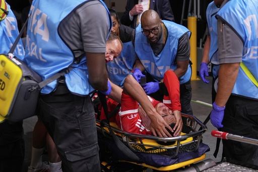 Bayern Munich's Jamal Musiala is taken off the field after an injury during the Club World Cup quarterfinal soccer match between PSG and Bayern Munich in Atlanta, Saturday, July 5, 2025. (AP Photo/Brynn Anderson)