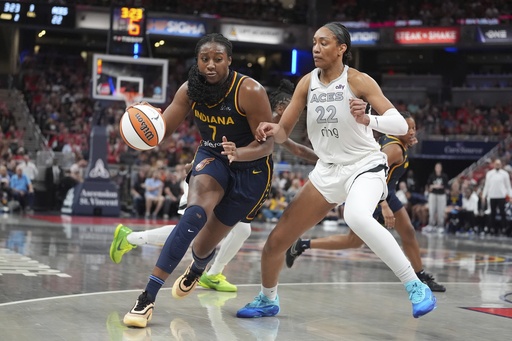 Indiana Fever's Aliyah Boston (7) goes to the basket against Las Vegas Aces' A'ja Wilson (22) during the first half of a WNBA basketball game, Thursday, July 3, 2025, in Indianapolis. (AP Photo/Michael Conroy)