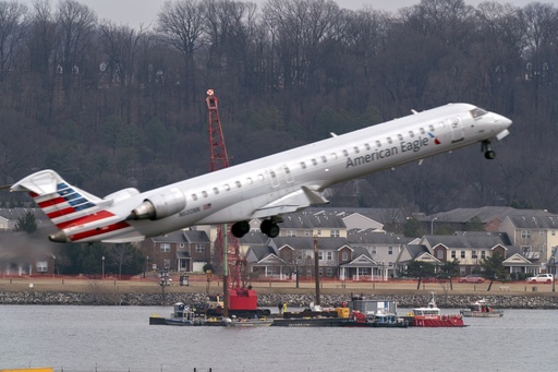 FILE - Salvage crews work on recovering wreckage near the site in the Potomac River of a mid-air collision between an American Airlines jet and a Black Hawk helicopter at Ronald Reagan Washington National Airport, Thursday, Feb. 6, 2025, in Arlington, Va. (AP Photo/Jose Luis Magana, File)