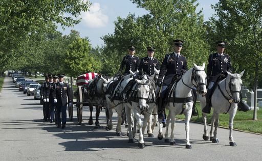 FILE - A U.S. Army Caisson team carries the casket of Army Capt. Stephanie Rader, during a full military honors conducted by the Army's 3rd U.S. Infantry Regiment through Arlington National Cemetery in Arlington, Va., June 1, 2016. (AP Photo/Molly Riley, File)