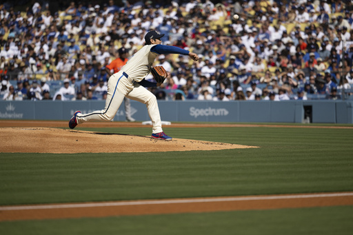 Los Angeles Dodgers starting pitcher Shohei Ohtani delivers during the first inning of a baseball game against the Houston Astros in Los Angeles, Saturday, July 5, 2025. (AP Photo/Kyusung Gong)