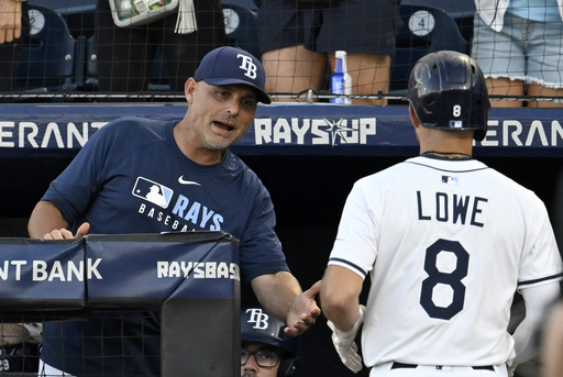 Tampa Bay Rays manger Kevin Cash congratulates Tampa Brandon Lowe after Lowe's home run during the third inning of a baseball game against the Athletics Tuesday, July 1, 2025, in Tampa, Fla. (AP Photo/Jason Behnken)