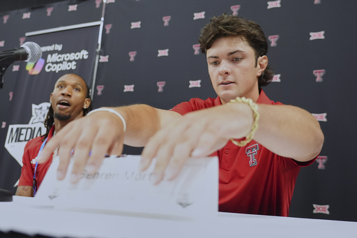 Texas Tech quarterback Behren Morton, right, takes as seat for interviews flanked by teammate wide receiver Caleb Douglas during the Big 12 NCAA college football media days in Frisco, Texas, Tuesday, July 8, 2025. (AP Photo/LM Otero)
