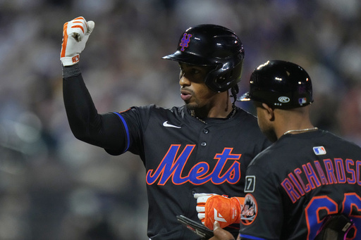 New York Mets' Francisco Lindor gestures to teammates after hitting an RBI single during the sixth inning in the second baseball game against the Milwaukee Brewers of a doubleheader Wednesday, July 2, 2025, in New York. (AP Photo/Frank Franklin II)