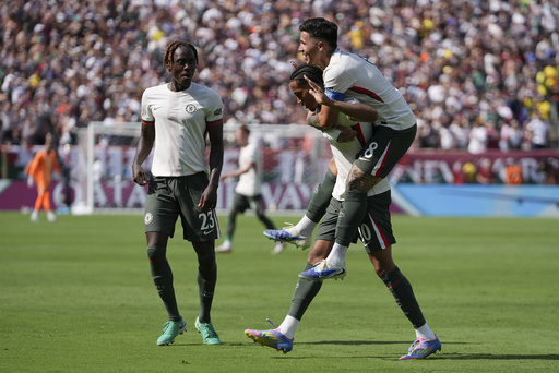 Chelsea's Joao Pedro celebrates with Enzo Fernandez, right, and Trevoh Chalobah, left, after scoring a goal against Fluminense during the second half of a Club World Cup semifinal soccer match in East Rutherford, N.J., Tuesday, July 8, 2025. (AP Photo/Frank Franklin II)