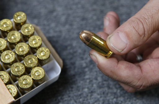 FILE - Chris Puehse, owner of Foothill Ammo, displays .45-caliber ammunition for sale at his store in Shingle Springs, Calif., June 11, 2019. (AP Photo/Rich Pedroncelli, File)
