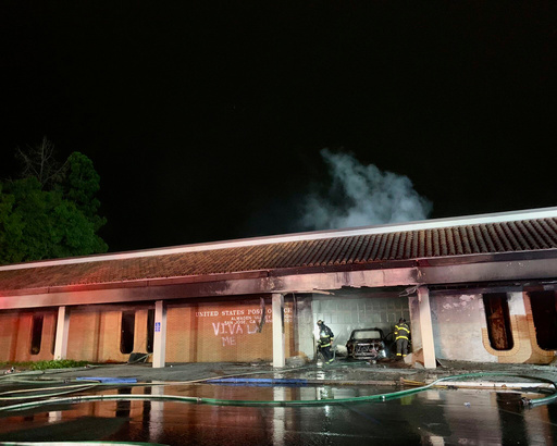 This photo provided by the San Jose Fire Department shows firefighters responding to a fire burning after a car crashed into the Post Office, early Sunday, July 20, 2025, in San Jose, Calif. (San Jose Fire Department via AP)