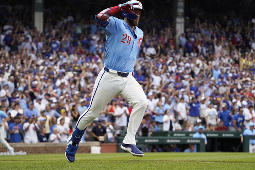 Chicago Cubs' Michael Busch runs the bases and gestures after hitting a two-run home run against the St. Louis Cardinals during the third inning of a baseball game, Friday, July 4, 2025, in Chicago. (AP Photo/David Banks)