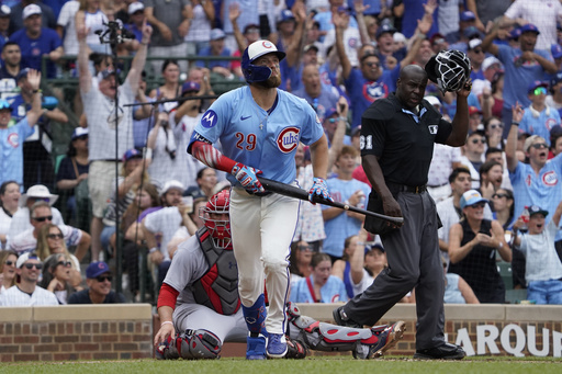 Chicago Cubs' Michael Busch hits a two-run home run against the St. Louis Cardinals during the third inning of a baseball game Friday, July 4, 2025, in Chicago. (AP Photo/David Banks)