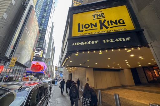 FILE — People walk in front of the Minskoff Theatre where "The Lion King" plays on Broadway in New York, Nov. 16, 2023. (AP Photo/Ted Shaffrey, File)