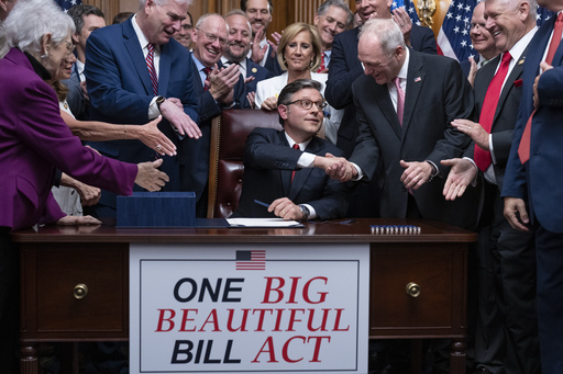 Speaker of the House Mike Johnson, R-La., center, shakes hands with Majority Leader Steve Scalise, R-La., as he celebrates with fellow Republicans after final passage of President Donald Trump's signature bill of tax breaks and spending cuts, at the Capitol in Washington, Thursday, July 3, 2025. (AP Photo/J. Scott Applewhite)